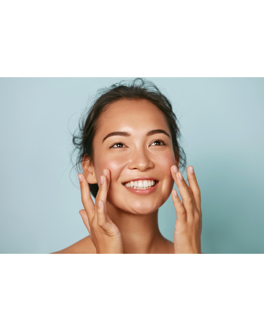 A concerned woman touching the skin on her face.