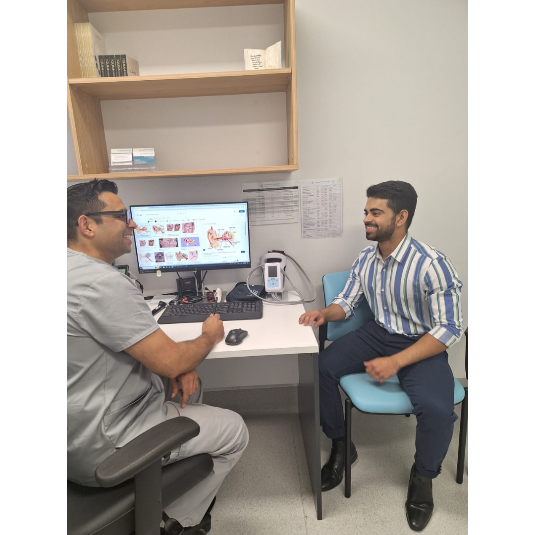 Dr. Chaudry consulting with a patient in the clinic.